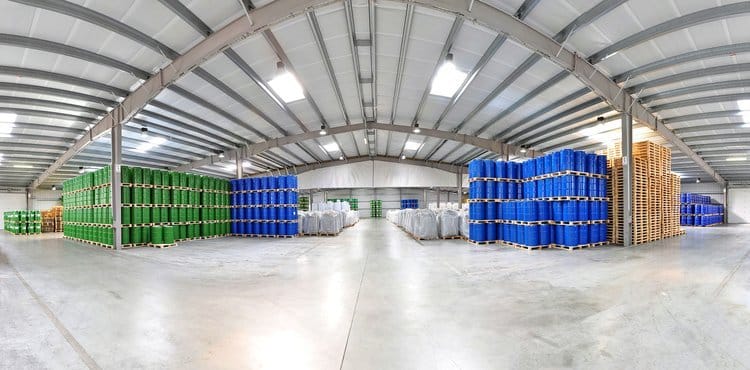 Rows of tagged chemical bins in a warehouse tracked by RTLS for inventory visibility