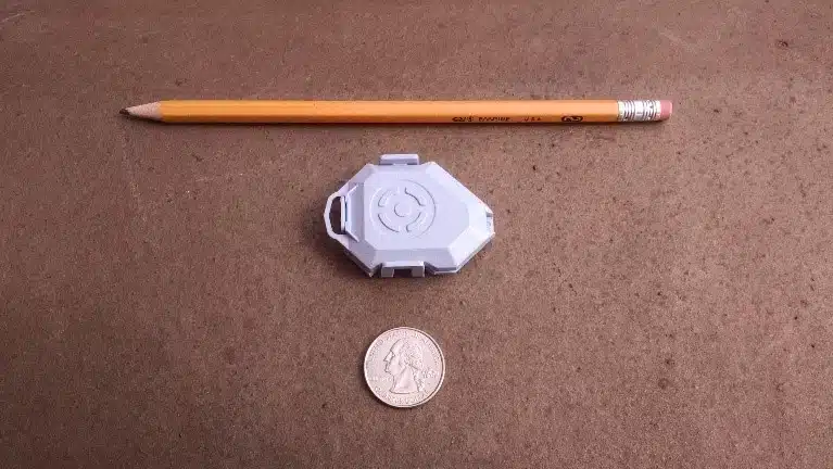 WISER tag size comparison to coin and pencil